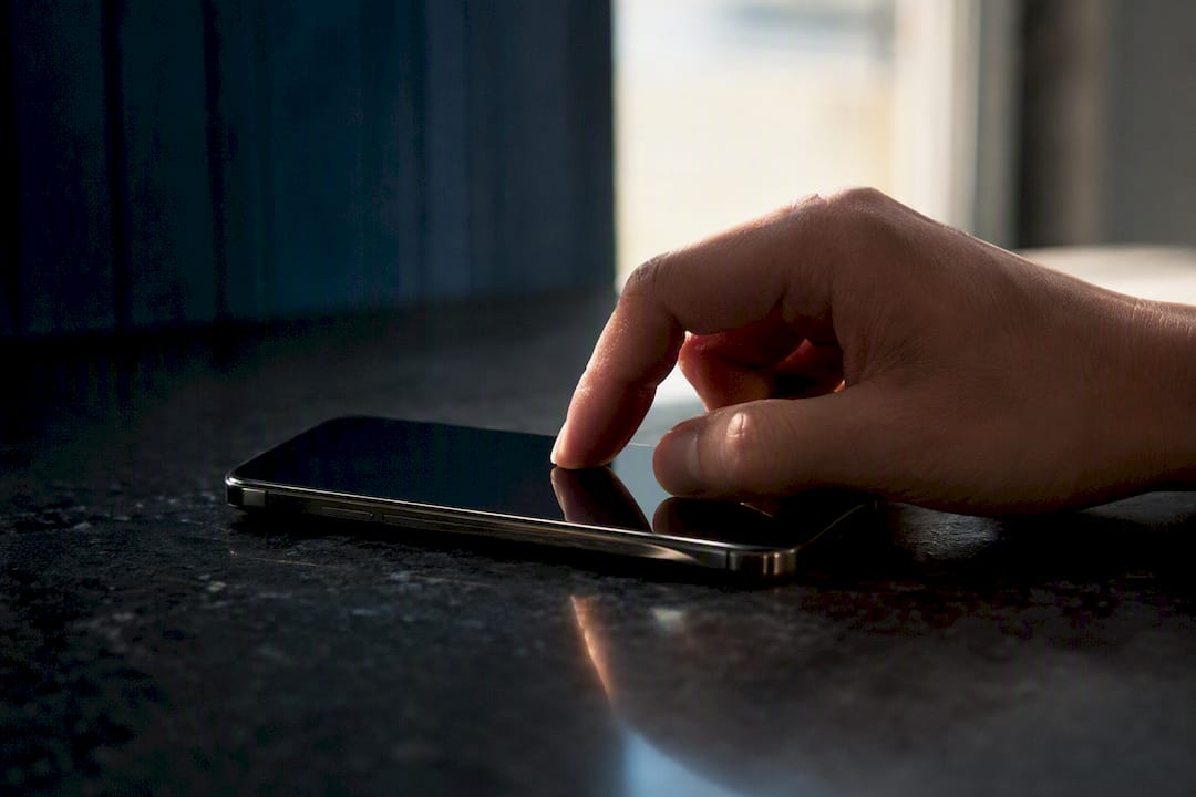 Thumb tapping large touch target on smartphone
