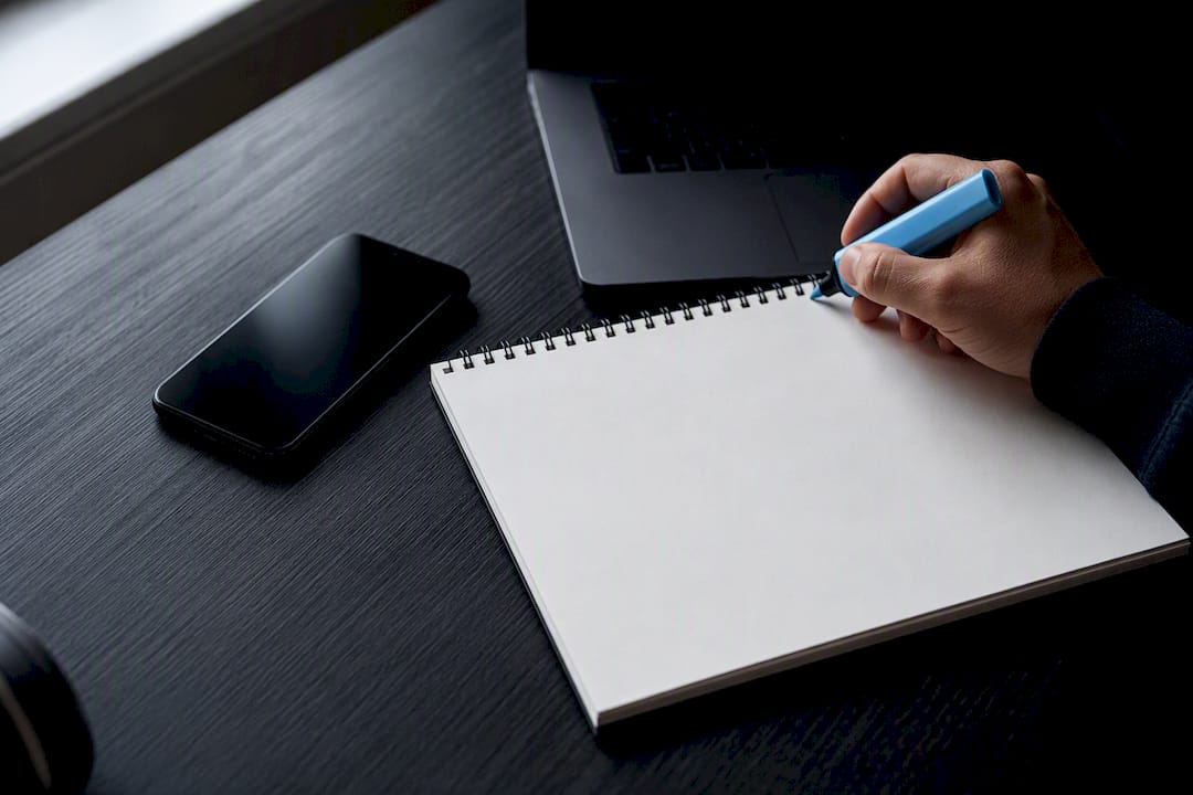 Smartphone and pen poised for message template planning